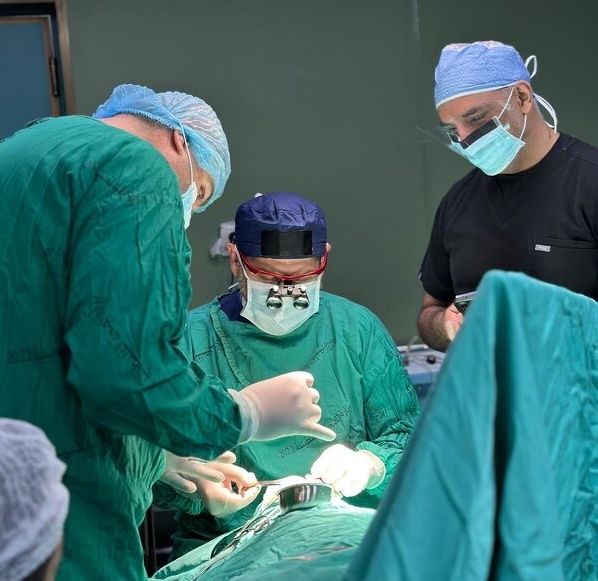 Dr. Adam Hamawy and his colleagues perform a surgical operation on a patient while volunteering at Nasser Hospital in Gaza, following the Israel-Hamas ceasefire.