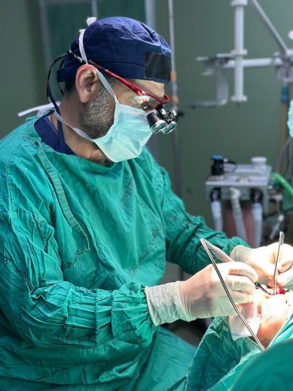 Dr. Adam Hamawy performs surgery on a patient while volunteering at Nasser Hospital in Gaza, following the Israel-Hamas ceasefire agreement.