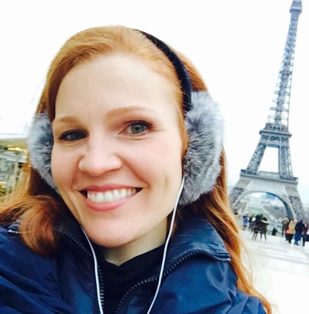 The author in Paris on her first-ever solo trip, celebrating her 35th birthday with the Eiffel Tower behind her.