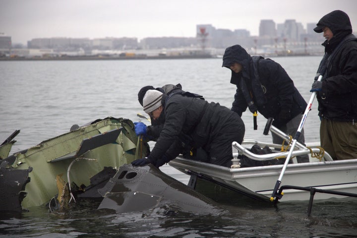 NTSB investigators and members of a salvage crew recover wreckage from the Army Black Hawk helicopter that collided with an American Airlines jet near Ronald Reagan Washington National Airport last month.