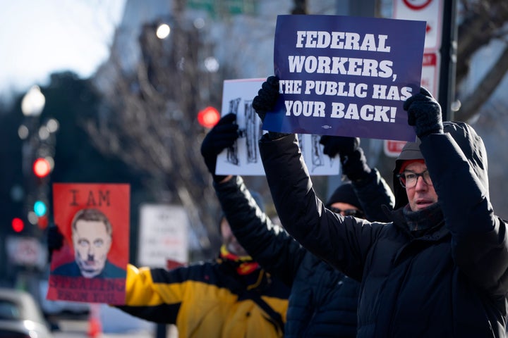 Demonstrators rally in support of federal workers outside of the Department of Health and Human Services, Friday, Feb. 14, 2025, in Washington. (AP Photo/Mark Schiefelbein)