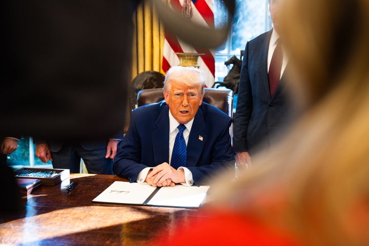 U.S. President Donald Trump speaks to the press before signing an executive order on halting federal funds for schools and universities that impose coronavirus vaccine mandates in the Oval Office of the White House on Friday February 14, 2025. (Photo by Demetrius Freeman/The Washington Post via Getty Images)