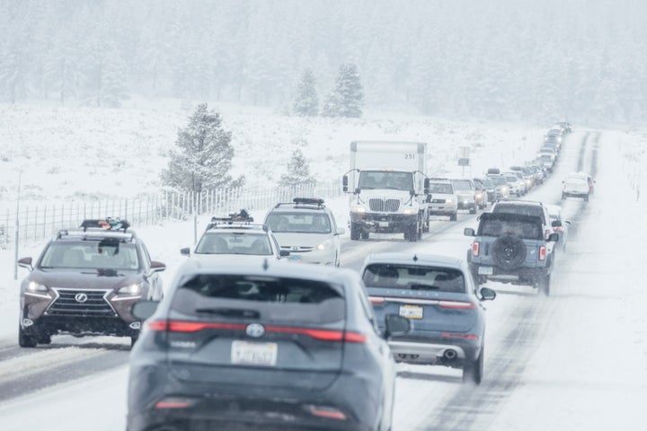 Motorists travel along a snow covered State Route 267 in Truckee, Calif., Friday, Feb. 14, 2025. (Stephen Lam/San Francisco Chronicle via AP)