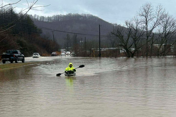 In this photo provided by Donnie Smith, a kayaker navigates floodwaters Saturday, Feb. 15, 2025, in rural Knox County, Ky. (Donnie Smith via AP)