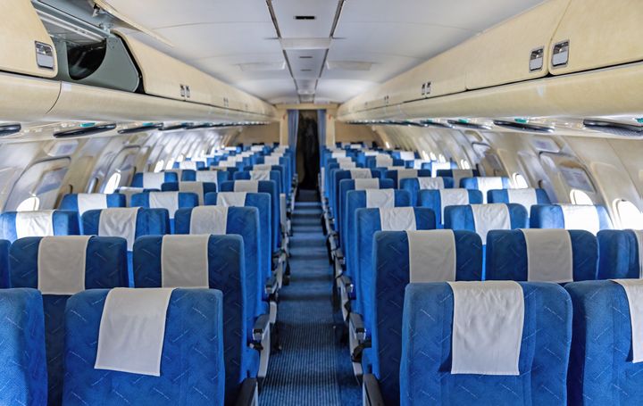 Interior of empty blue aircraft seats. Horizontally.