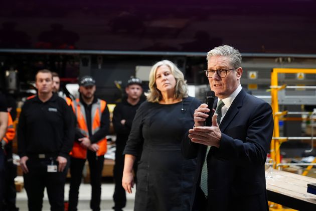 Britain's Prime Minister Keir Starmer and Transport Secretary Heidi Alexander, left, visit Hitachi in Newton Aycliffe, north east England, Friday Dec. 6, 2024.