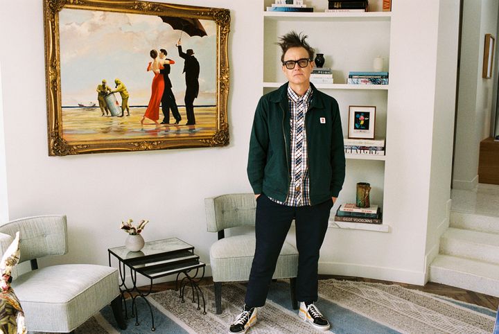 Mark Hoppus of Blink-182 poses by his painting Crude Oil (Vettriano) by Banksy (2005), which is being sold by Sotheby's on March 4 with some of the proceeds going to victims of the Los Angeles wildfires. (Max Montgomery/Sotheby's via AP)