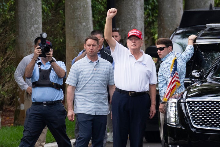 President Donald Trump gestures to supporters as he leaves the Trump International Golf Club on Feb. 17, 2025, in West Palm Beach, Florida. 