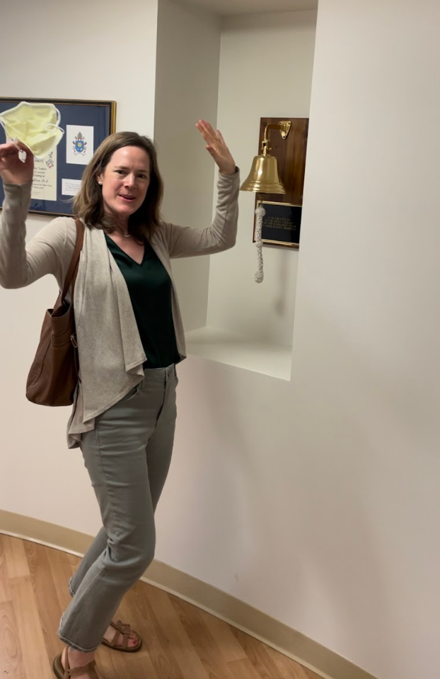 The author ringing a bell after finishing a month of radiation treatment at MedStar Georgetown University Hospital in Washington, D.C.