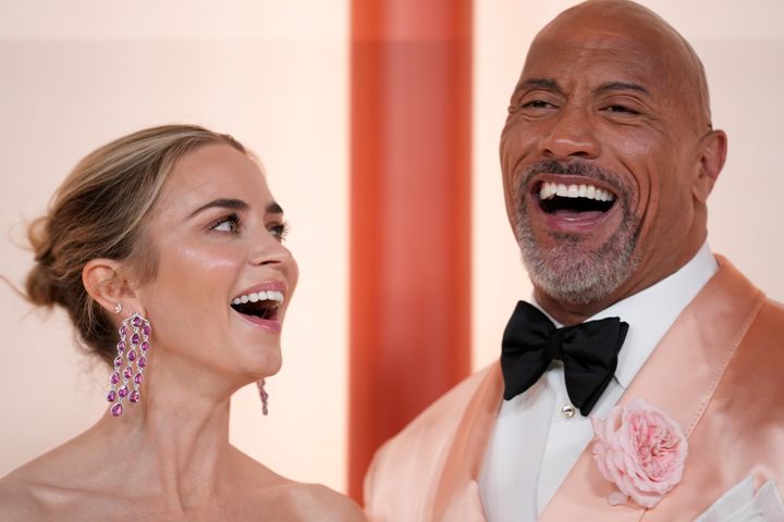 Emily Blunt, left, and Dwayne Johnson arrive at the Oscars on Sunday, March 12, 2023, at the Dolby Theatre in Los Angeles. (AP Photo/Ashley Landis)