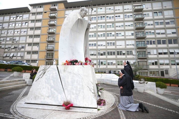 Nuns pray for Pope Francis in front of the statue of Pope John Paul II at the Agostino Gemelli Polyclinic, in Rome, on Feb. 20, 2025, where the Pontiff has been hospitalized since Feb. 14.