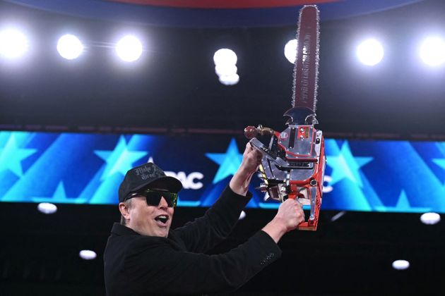 Elon Musk holds a chainsaw during the annual Conservative Political Action Conference (CPAC) at the Gaylord National Resort & Convention Center at National Harbor in Oxon Hill, Maryland, on February 20, 2025. 