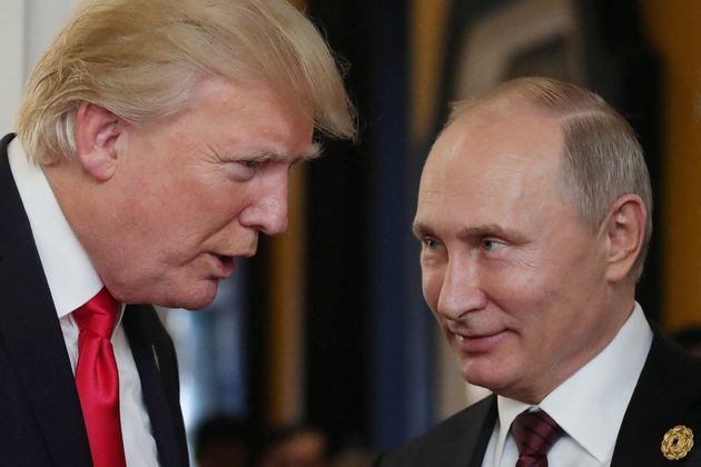 US President Donald Trump (L) chats with Russia's President Vladimir Putin as they attend the APEC Economic Leaders' Meeting, November 11, 2017. 