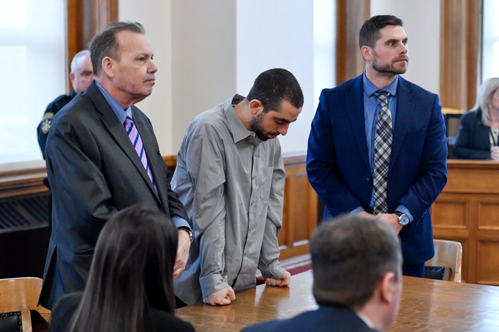 Hadi Matar, center, charged with severely injuring author Salman Rushdie in a 2022 knife attack, stands next to public defender Nathaniel Barone, left, and listens as the jury reads their verdict finding him guilty on all counts in Chautauqua County court in Mayville, N.Y.