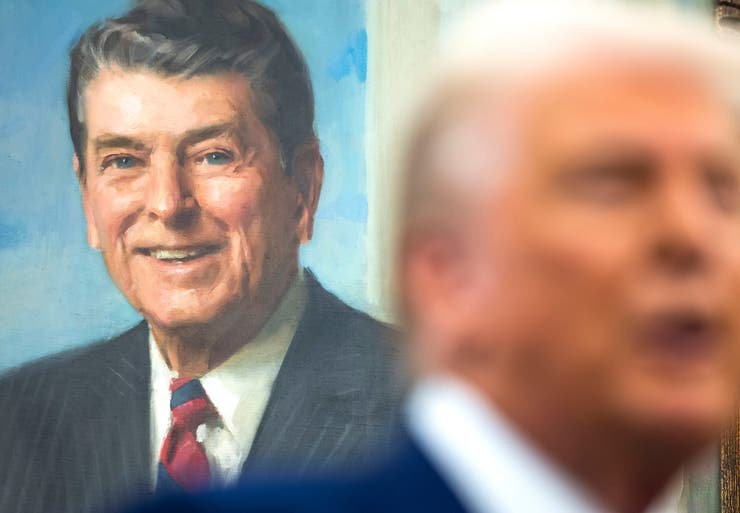 A painting of former U.S. President Ronald Reagan behind U.S. President Donald Trump.