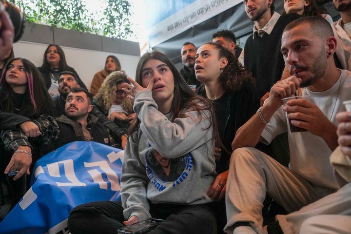 Relatives and friends of Eliya Cohen, 27, gather to watch the TV broadcast of his release by Palestinian militants in Gaza, in Tel Aviv, Israel, Saturday Feb. 22, 2025. (AP Photo/Ohad Zwigenberg)