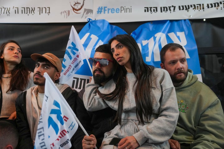 Relatives and friends of Eliya Cohen, 27, gather to watch the TV broadcast of his release by Palestinian militants in Gaza, in Tel Aviv, Israel, Saturday Feb. 22, 2025. (AP Photo/Ohad Zwigenberg)