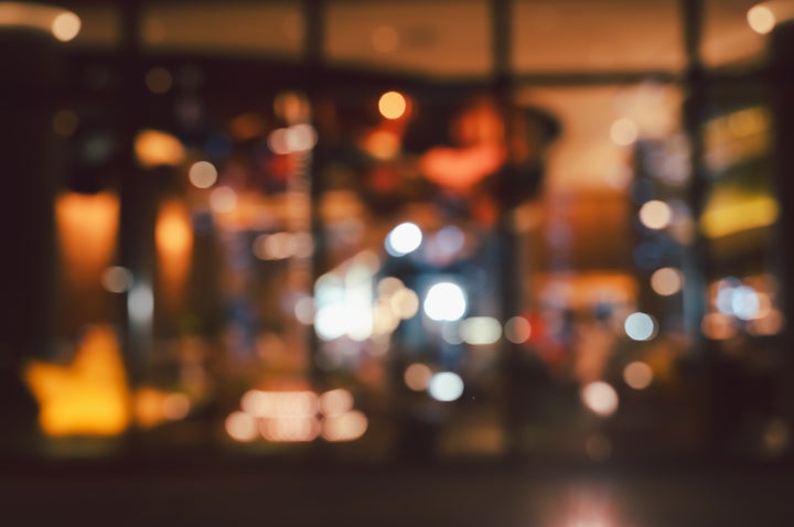 Blurred image of restaurant or cafe at night with bokeh background