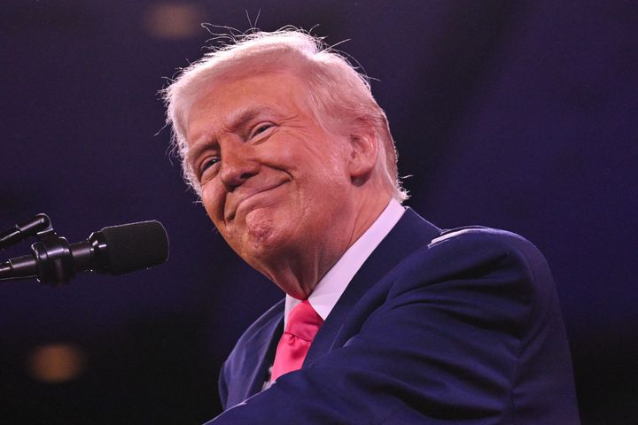 US President Donald Trump smiles as he addresses the annual Conservative Political Action Conference (CPAC) at the Gaylord National Resort & Convention Center at National Harbor ini Oxon Hill, Maryland, on February 22, 2025. (Photo by ROBERTO SCHMIDT / AFP) (Photo by ROBERTO SCHMIDT/AFP via Getty Images) 