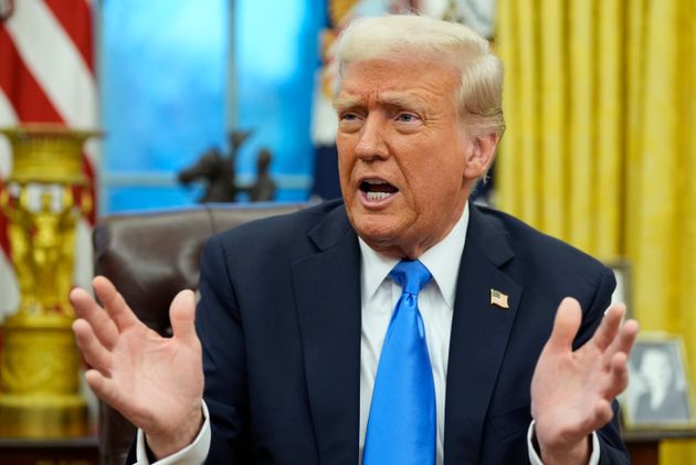 President Donald Trump speaks with reporters in the Oval Office.