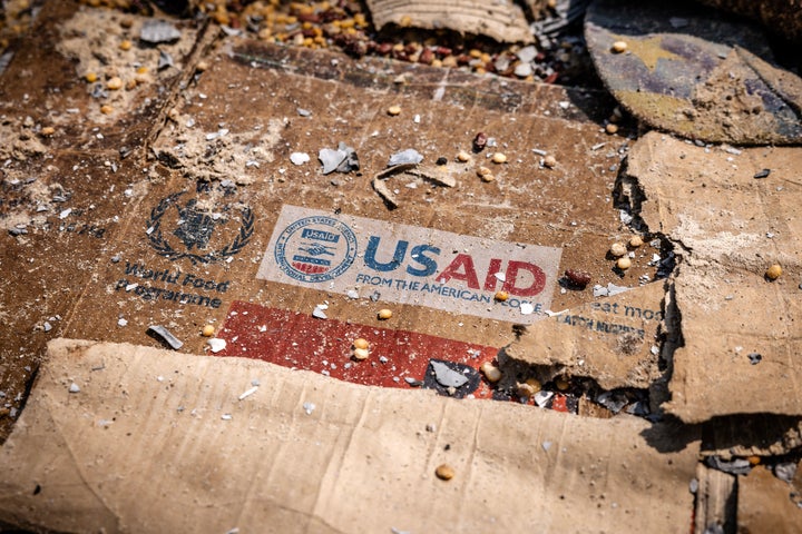 A USAID logo is visible on a box amid the scattered remains of materials left behind after widespread vandalism and looting at the World Food Programme warehouse in Bukavu, Congo, on Feb. 21.