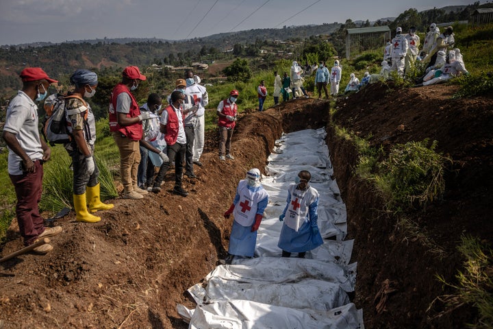 Members of the Congolese Red Cross carry bodybags containing human remains during a mass burial for victims of the clashes with Rwandan-backed rebels in eastern Democratic Republic of Congo in Bukavu on Feb. 20.