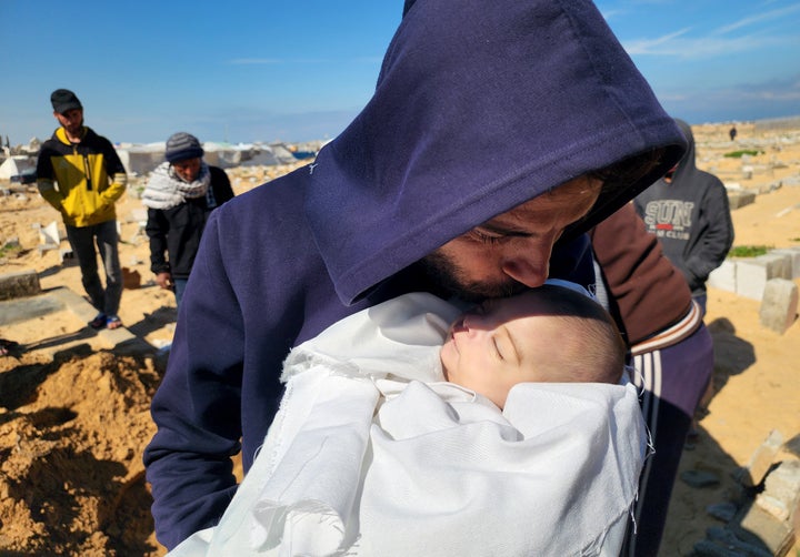 (EDITOR'S NOTE: Image depicts death) A relative kisses the body of 2-month-old Shem Al-Shambari, who died of extreme cold in the family's makeshift tent, before she is buried in a cemetery in Khan Younis, Gaza, on Feb. 25, 2025.