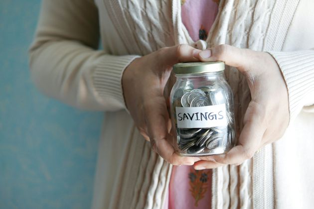 Older woman holding a savings jar