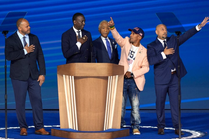 Rev. Al Sharpton (C) appears on stage with members of The Exonerated Five -- from left, Kevin Richardson, Yusef Salaam, Korey Wise and Raymond Santana, during the Democratic National Convention on Aug. 22, 2024, in Chicago.