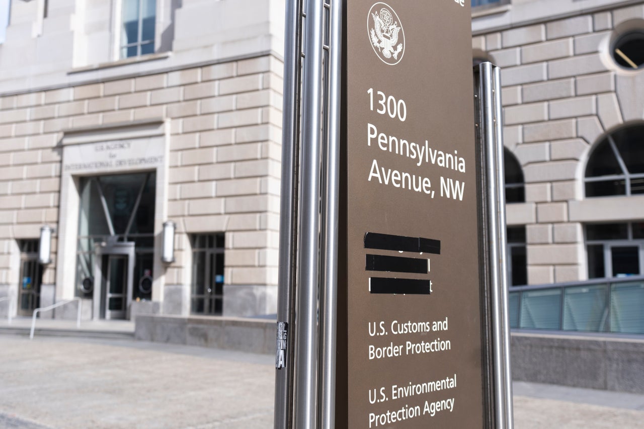 Black tape covers the name of USAID on a street sign outside of its former offices. The agency is being dismantled by Trump and is at the heart of questions of executive power.