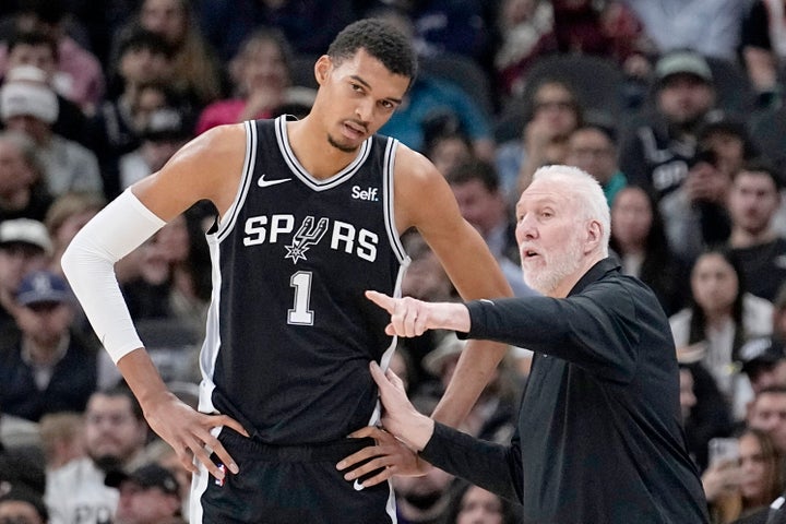 San Antonio Spurs head coach Gregg Popovich, right, talks with center Victor Wembanyama (1) during the first half of an NBA basketball game against the Los Angeles Lakers in San Antonio, Wednesday, Dec. 13, 2023. (AP Photo/Eric Gay, File)