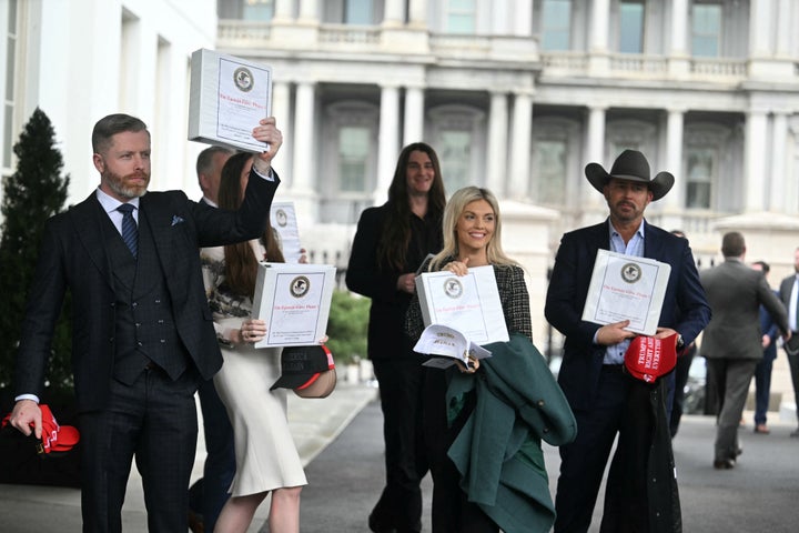 Political commentator Rogan O'Handley, aka DC Draino, and others carrying binders bearing the seal of the US Justice Department reading "The Epstein Files: Phase 1" walk out of the West Wing of the White House on Feb. 27.