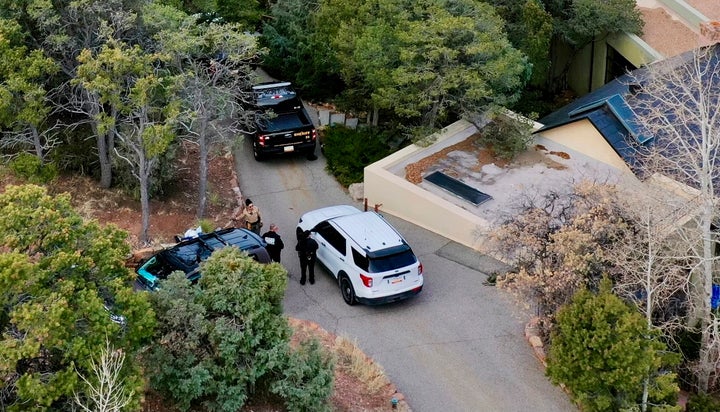 Law enforcement officials talk outside the home of actor Gene Hackman on Thursday, Feb. 27 in Santa Fe, New Mexico. 