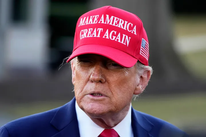 President Donald Trump talks with reporters before boarding Marine One on the South Lawn of the White House in Washington, Friday, Feb. 28, 2025. (AP Photo/Ben Curtis)