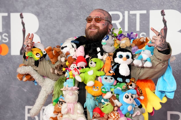 Teddy Swims in a teddy-adorned suit at the 2025 Brit Awards