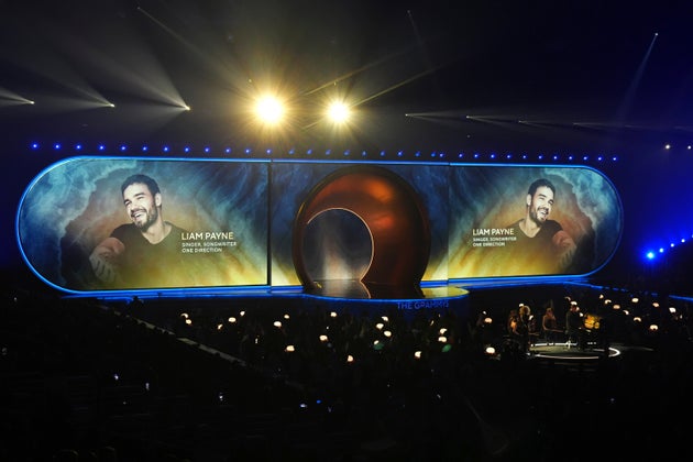 Chris Martin performs 'All My Love' for the In Memoriam segment with an imagine of Liam Payne on the screen behind him during the 67th annual Grammy Awards on Sunday, Feb. 2, 2025, in Los Angeles. (AP Photo/Chris Pizzello)