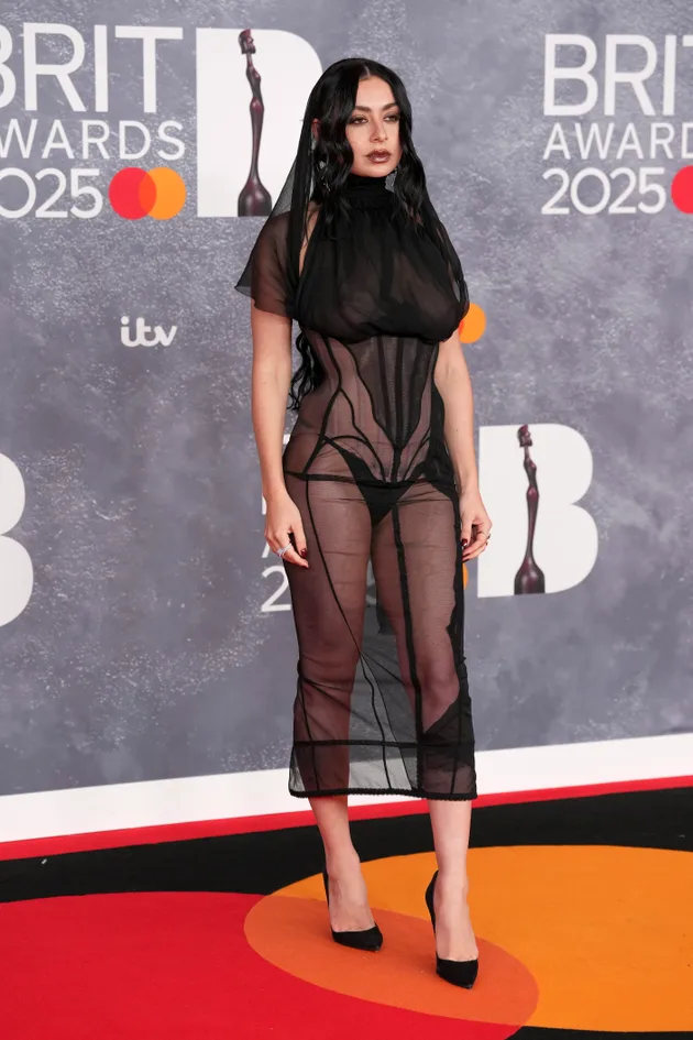 Charli xcx in a black veil and heavy-seamed fine-mesh black dress