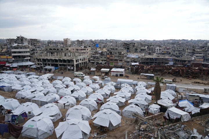 A sprawling tent camp for displaced Palestinians sits adjacent to destroyed homes and buildings in Gaza City, Gaza Strip, Saturday, March 1, 2025 during the Muslim holy month of Ramadan. (AP Photo/Abdel Kareem Hana)