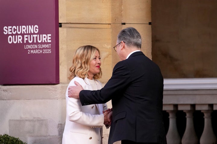 Britain's Prime Minister Keir Starmer, right, greets Italy's Prime Minister Giorgia Meloni as she arrives for a summit on Ukraine at Lancaster House in London, Sunday, March 2, 2025. (AP Photo/Christophe Ena, Pool)