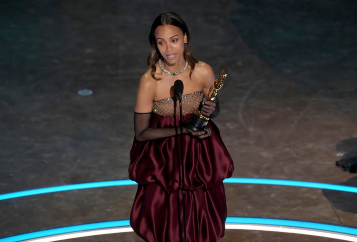 Zoe Saldaña accepts an Oscar for her role in "Emilia Pérez" during the Oscars on Sunday. 