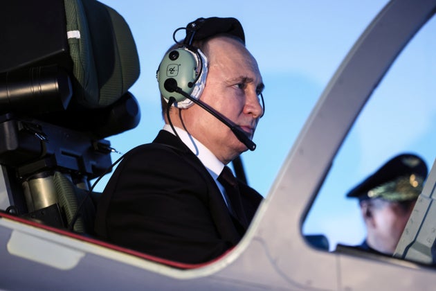 Russian President Vladimir Putin sits in a cockpit of a flight simulator at the Krasnodar Higher Military Aviation School of Pilots named after Anatoly Serov in Krasnodar, Russia, Thursday, March 7, 2024.