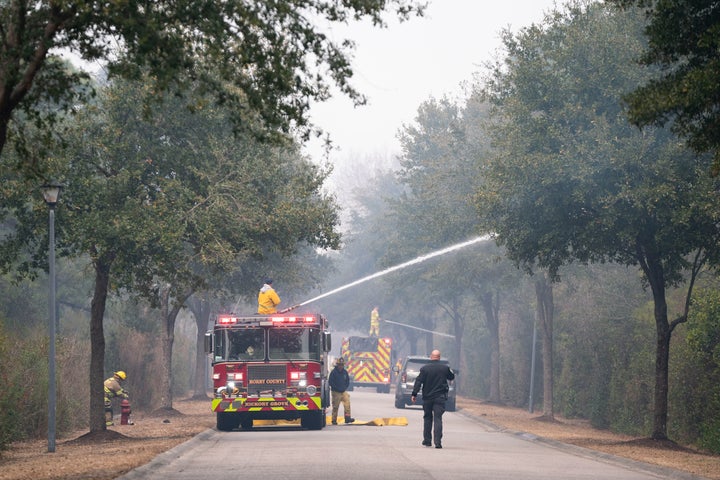 Firefighters battle a blaze in the Carolina Forest neighborhod on March 2, 2025 in Myrtle Beach, South Carolina. Multiple forest fires in the area have caused evacuations along the South Carolina coast.