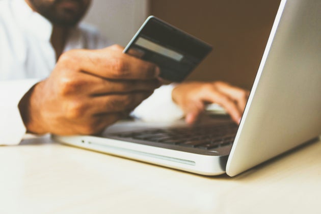 Man entering card details on laptop