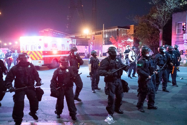 Washington Metropolitan Police Department police officers push back demonstrators on Oct. 28, 2020, following the death of Karon Hylton-Brown.