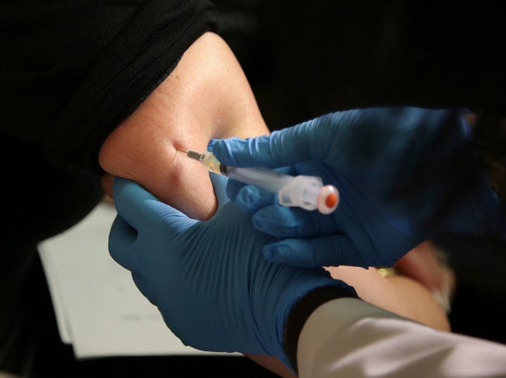 A woman receives a measles, mumps and rubella vaccine in New York. There are more than 150 measles cases in Texas.