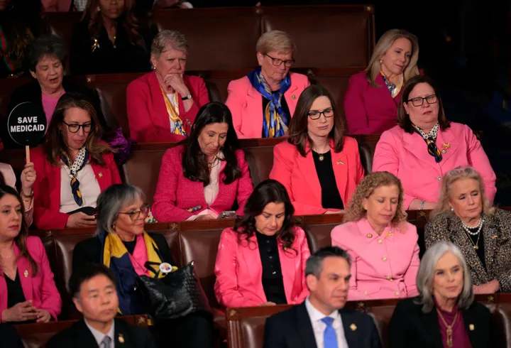 Democratic members of the House Women's Caucus wear pink as President Donald Trump addresses a joint session of Congress at the U.S. Capitol on Tuesday in Washington, D.C.