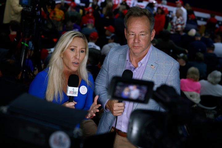 Rep. Marjorie Taylor Greene (R-Ga.) joins Right Side Broadcasting Network's Brian Glenn on camera during a campaign rally for Republican presidential candidate and then-former President Donald Trump at the Forum River Center on March 9, 2024, in Rome, Georgia. 