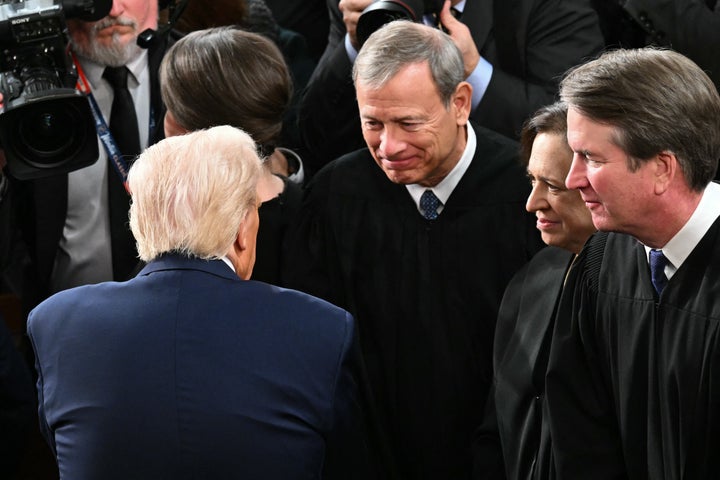 Donald Trump greets Supreme Court Chief Justice John Roberts after the president's address to a joint session of Congress.