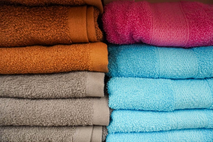 Close-up of stacks of colorful towels in supermarket