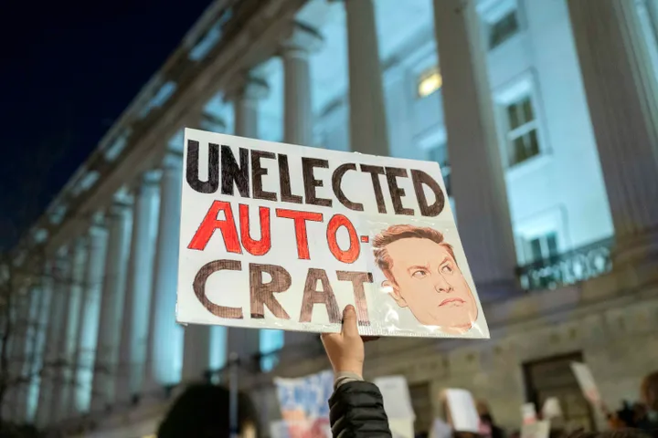 People protest against Elon Musk outside the Treasury Department in Washington on Feb. 4, 2025. 